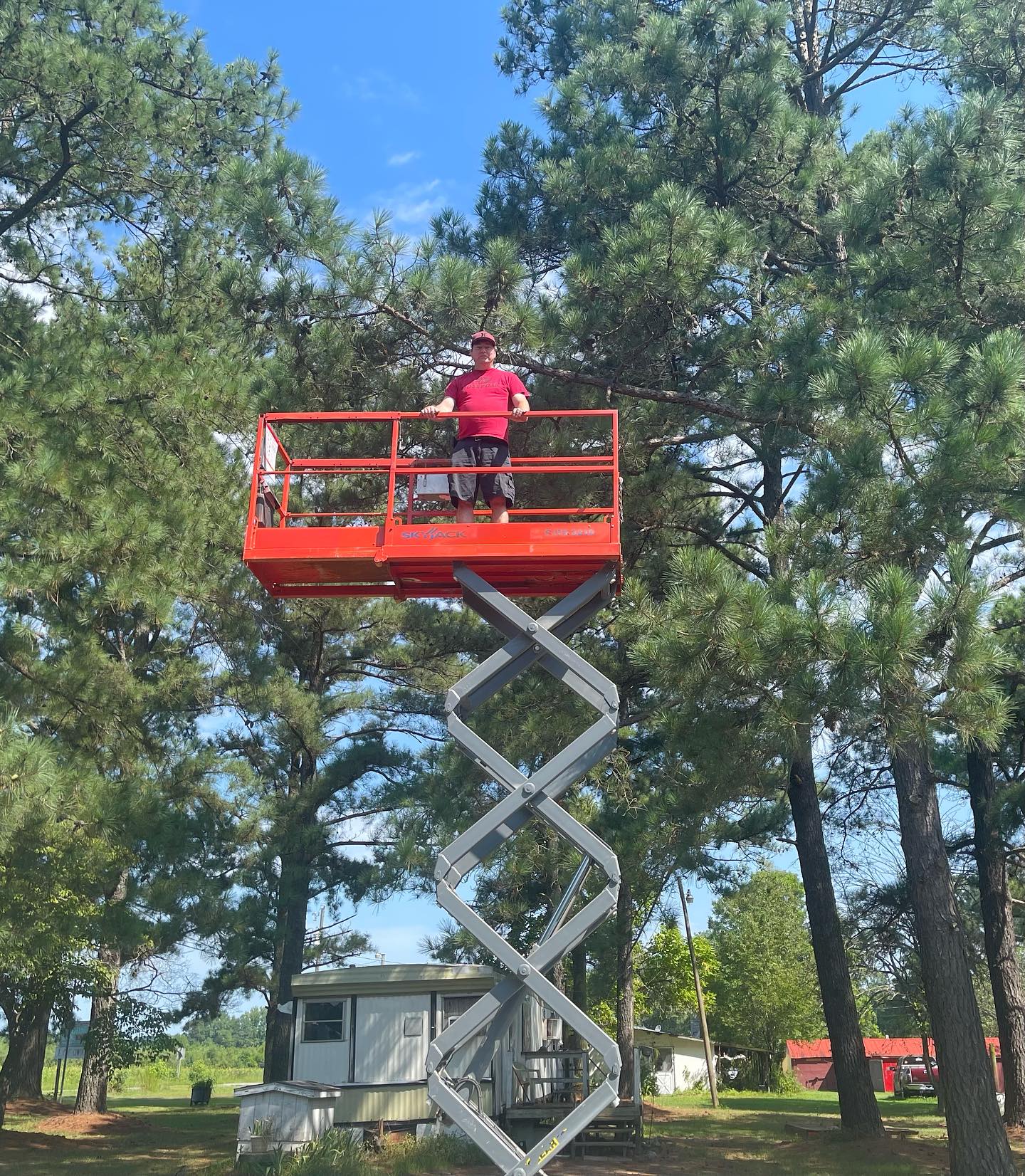 Tequila Sunrise Music technician working from a scissor lift on an installation
